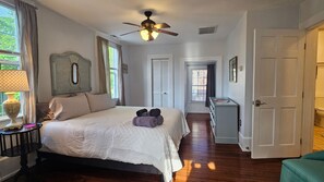 A bedroom with a bed, a ceiling fan, a nightstand, a lamp, and a dresser. - Historic 3-bedroom house in downtown Brooklyn Arts district (Wilmington)