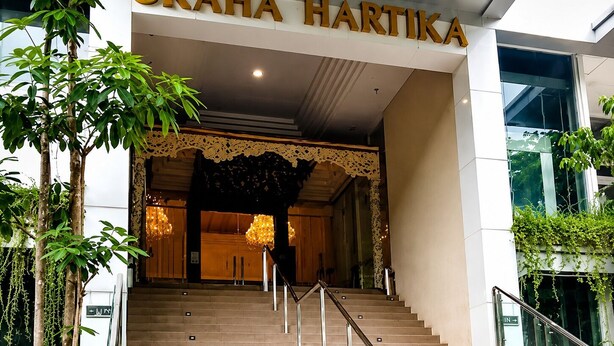 A hotel entrance with a staircase leading up to a reception area.