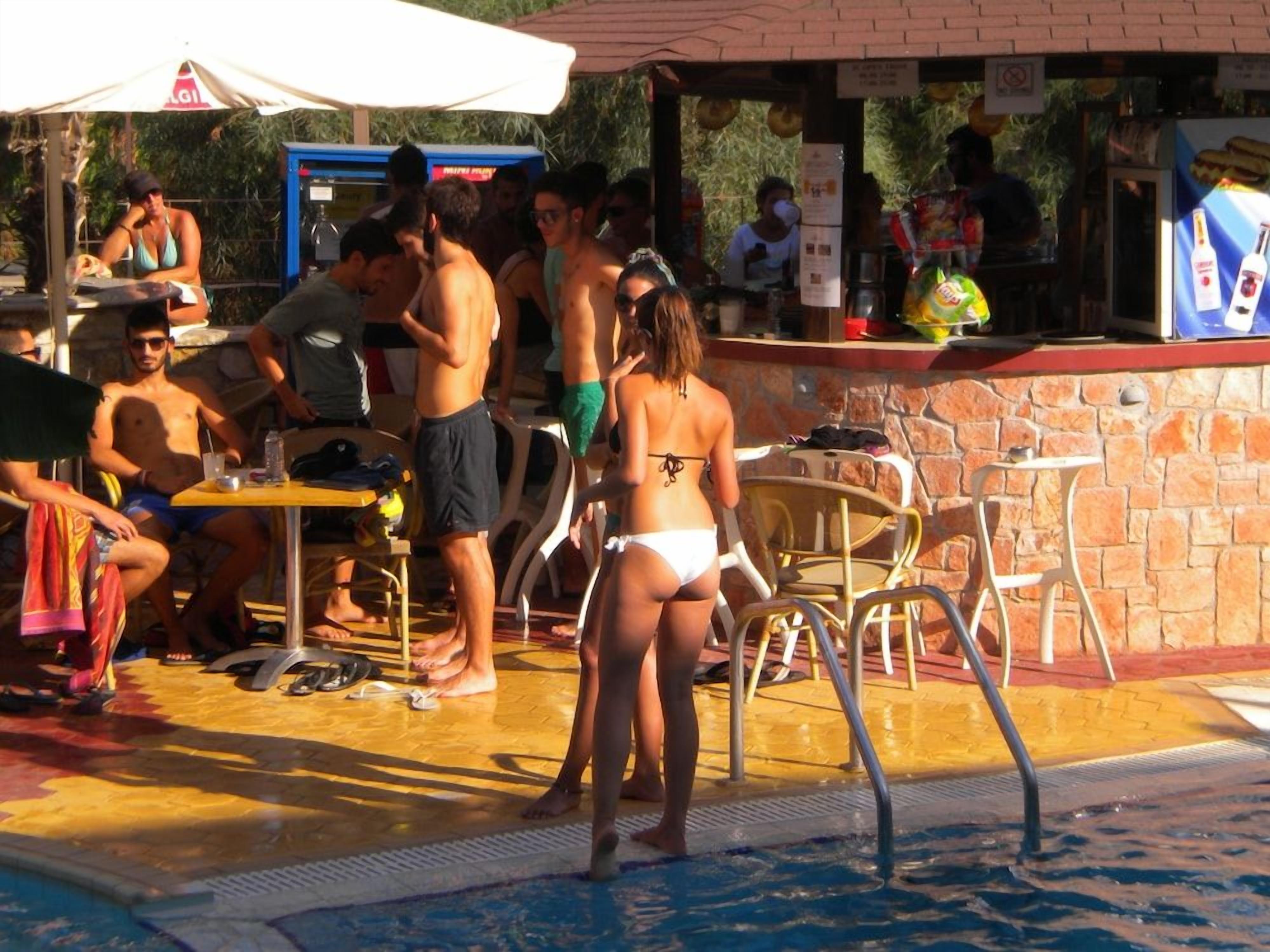 A poolside area with a bar and seating arrangements.