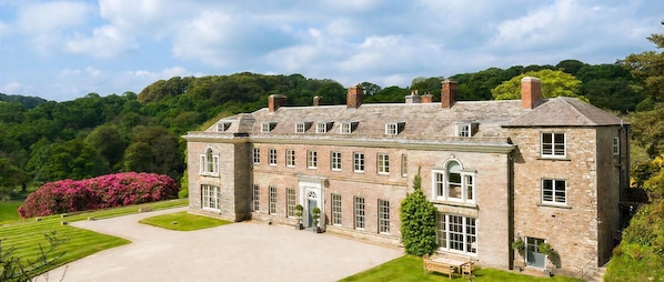 A large stone building with multiple windows and a central entrance.