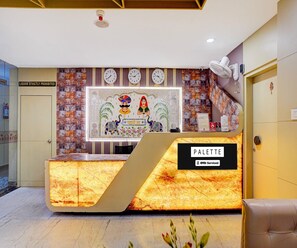 A reception desk with a sign reading 'PALETTE' and a clock above it. - Suite Room Amar Resorrt (Motihari)