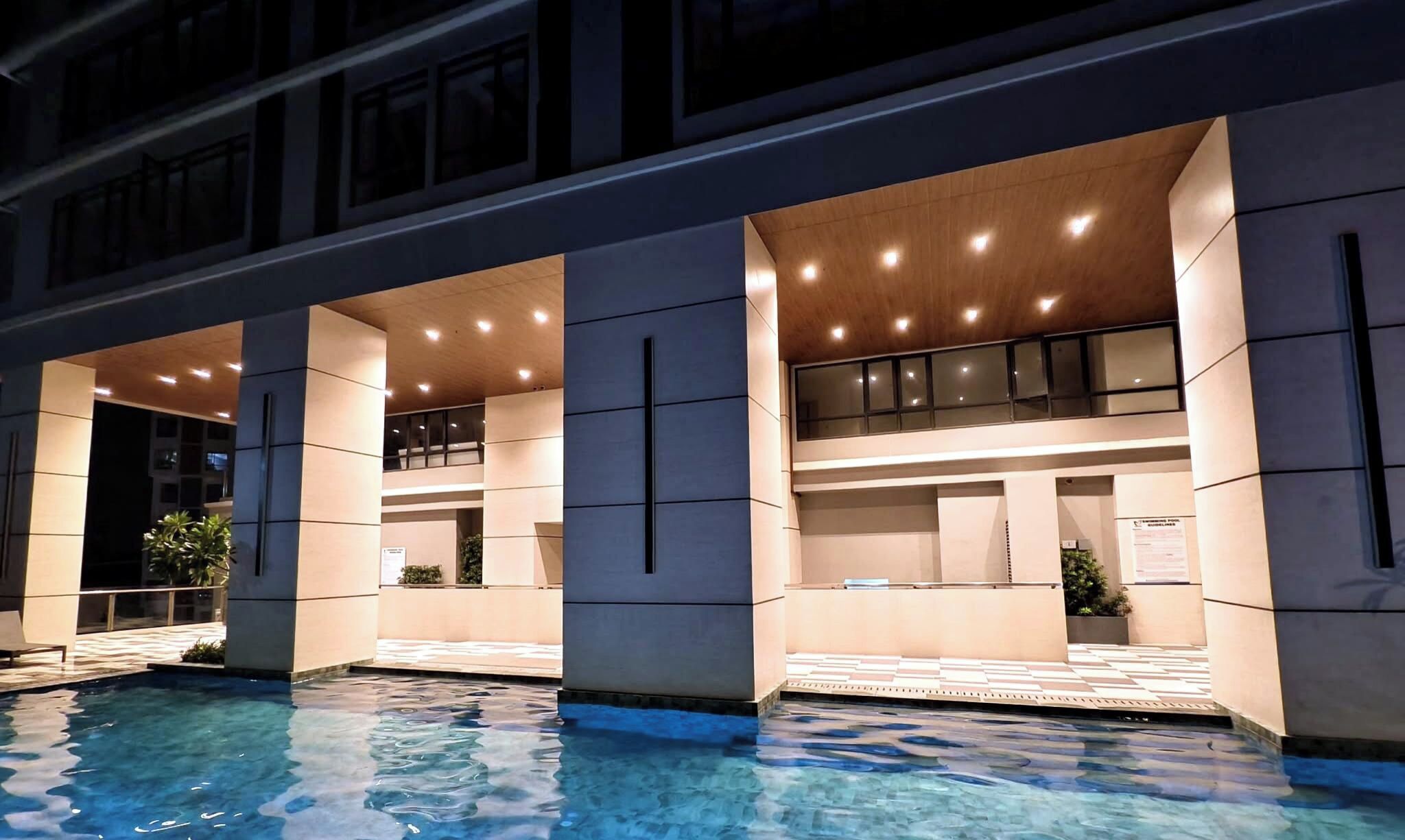 A hotel with a swimming pool, multiple levels, and a modern architectural design.