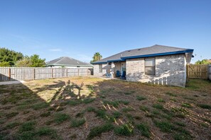 A residential property with a detached garage, a covered patio, and a fenced backyard. - Cute 2 bedroom home in port Isabel with backyard (Port Isabel)