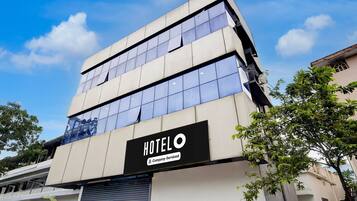 A multi-story building with a sign indicating it is a hotel.