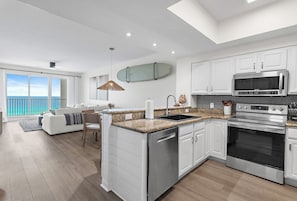 A modern kitchen with white cabinetry, a built-in microwave, and an oven. - ⛱️Walk to Beach | Gulf Views | Kids Fountain | 2 Pools | Ariel Dunes I 1203☀️ (Miramar Beach)