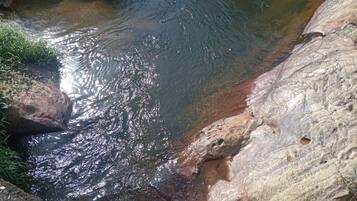 A natural water stream flowing over rocks.