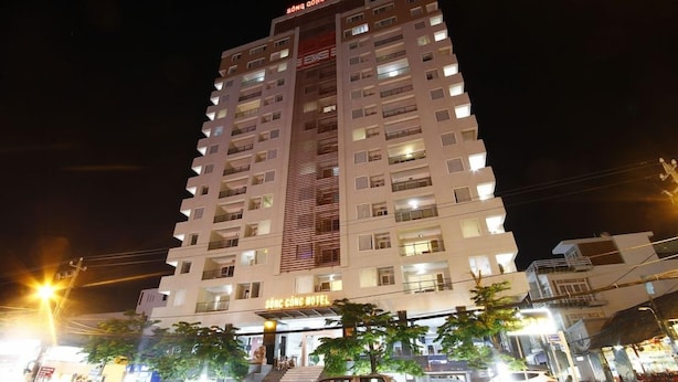 A multi-story hotel with a prominent entrance, visible balconies, and a staircase leading to the entrance. - Song Cong Hotel Danang (Da Nang Municipality)
