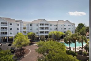 A multi-story hotel with balconies and a swimming pool. - Folly Road Retreat - Folly Beach Monthly Rental (Folly Beach)