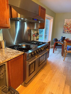 A kitchen with a stainless steel range, wooden cabinets, and a granite countertop. - Private Berkshire Retreat 9 Acres, Fenced Yard & Dogs Welcome (Otis)