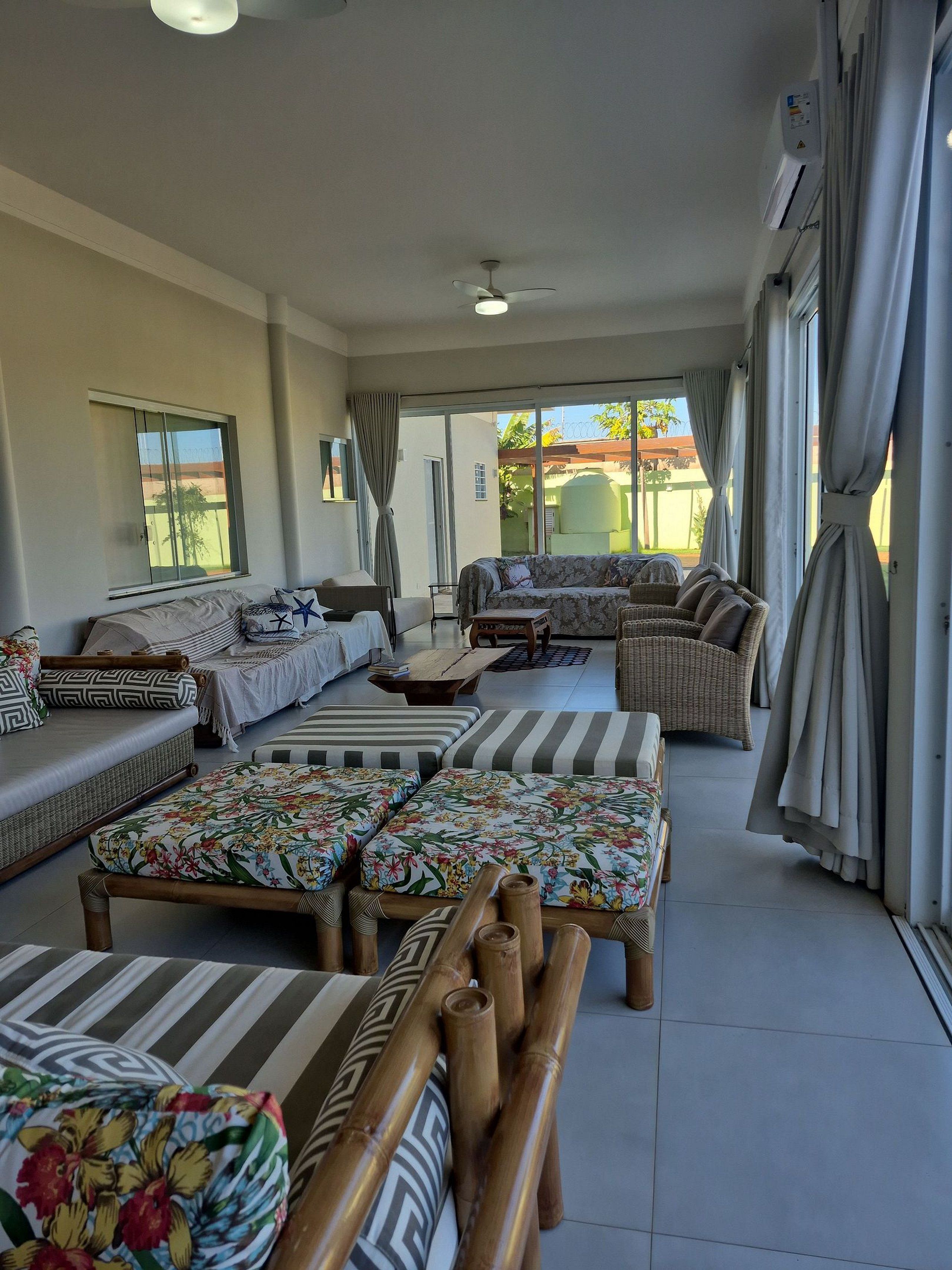 A spacious living area with a sofa set, a coffee table, and a view of the outside.