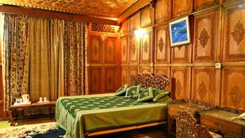 A room with a bed, a nightstand, and a wooden dresser.