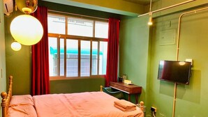 A room with a bed, a desk, a chair, a television, and a window with curtains. - Loft.wo Design Inn (Tainan)
