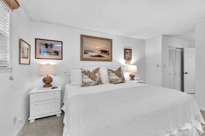 A bedroom with a large bed, two bedside tables with lamps, a nightstand, and framed artwork on the walls. - 3 Bedroom- Seascape Golf and Beach Resort (Miramar Beach)