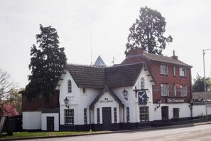 A traditional building with a sign reading 'CHEF & BREWER' and 'The Crossroads.'