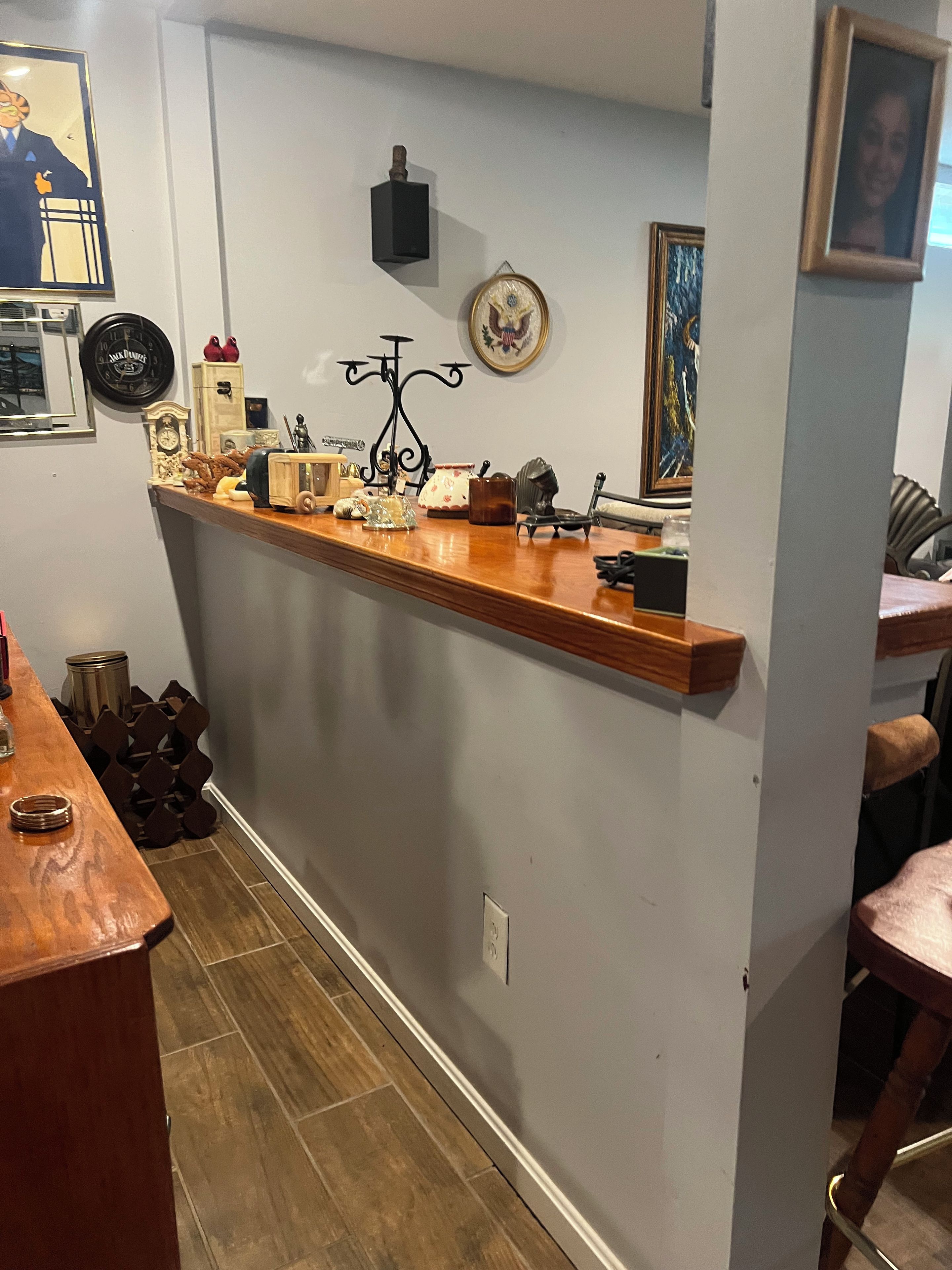 A kitchen with a wooden countertop, a clock, and various kitchen items.