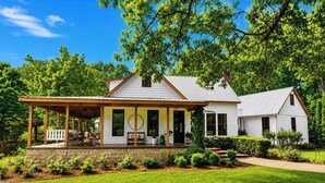 A two-story house with a covered porch and a stone foundation. - The Acres, 4BR Farm Stay by Velvet Ditch Villas (Oxford)