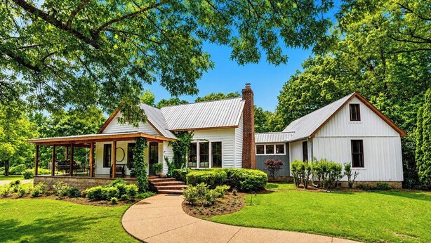 A two-story house with a covered porch, a brick chimney, and a well-maintained lawn. - The Acres, 4BR Farm Stay by Velvet Ditch Villas (Oxford)