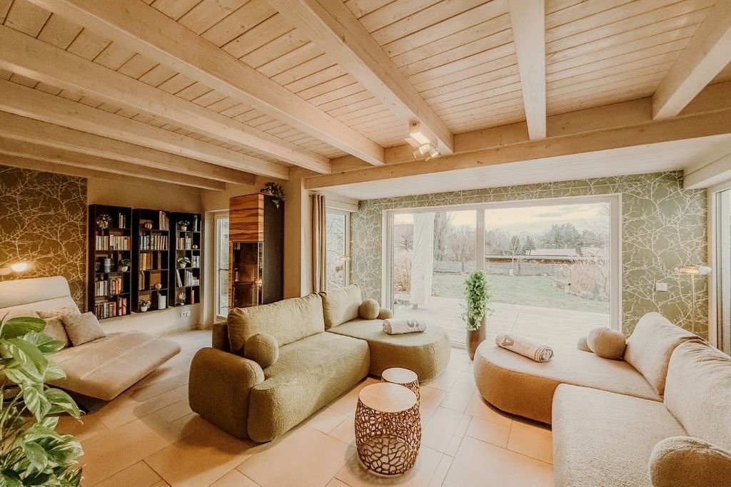 A modern living room with a sectional sofa, a coffee table, and a bookshelf.