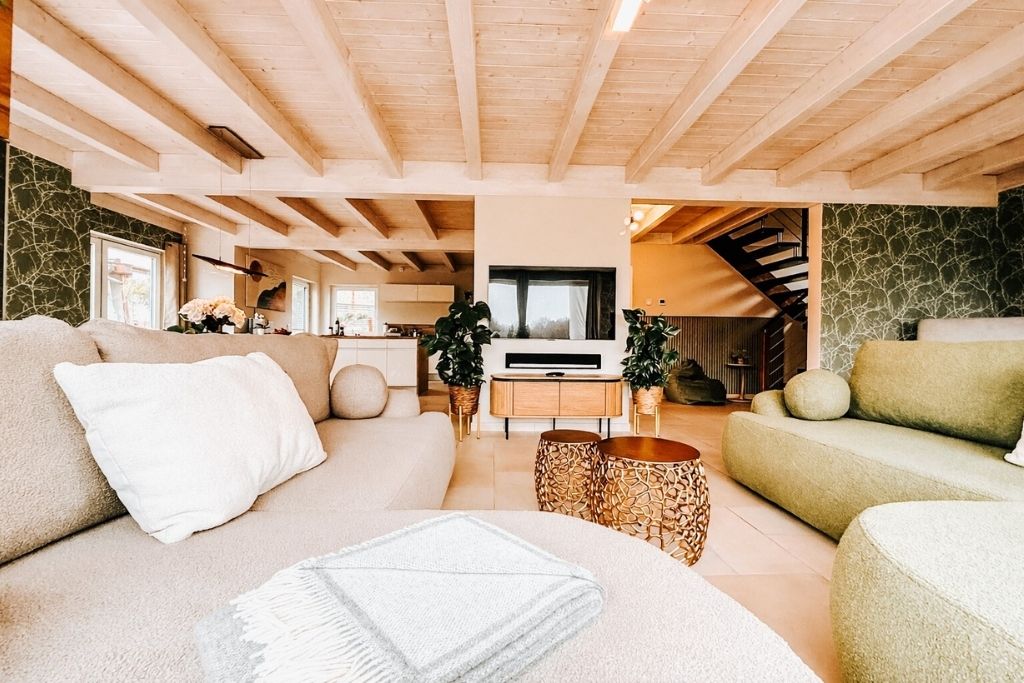 A spacious living area with a sofa, a coffee table, and a fireplace.