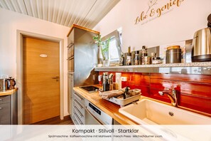 A compact kitchen with a stove, sink, and various appliances.