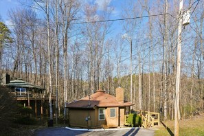 A small cabin with a single-story structure, a chimney, and a deck area. - Charming Retreat w/ Hot Tub in Gatlinburg (Gatlinburg)