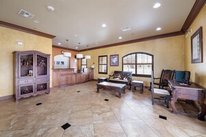 A spacious room with a wooden cabinet, a bench, and a desk.