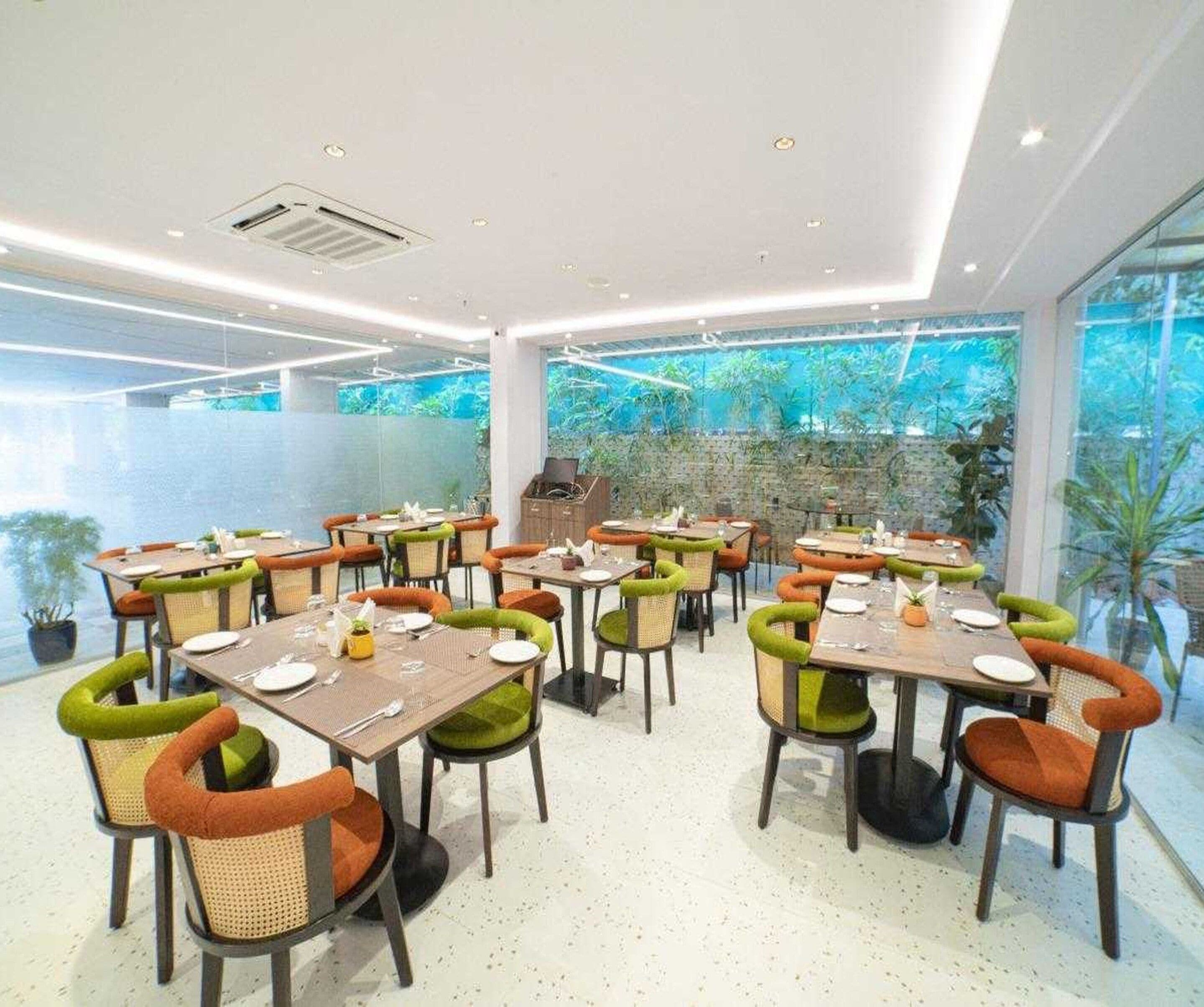 A restaurant with tables and chairs arranged for dining.