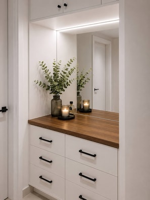 A modern bathroom with a wooden vanity, a mirror, and a potted plant. - Luxury Suite * POOL * BBQ * DOWNTOWN PUNTA CANA (Punta Cana)