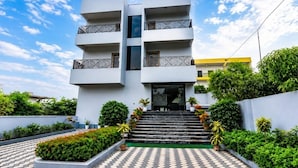 A modern multi-story building with a central staircase leading to the entrance. - Classic Gran-villa (Lalbag)