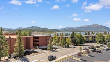 A parking lot with a view of mountains and a lake.