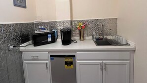 Una cocina equipada con lavavajillas, microondas y fregadero.