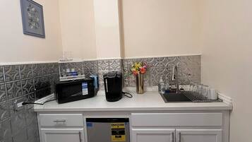 A kitchen with a dishwasher, a microwave, and a sink.