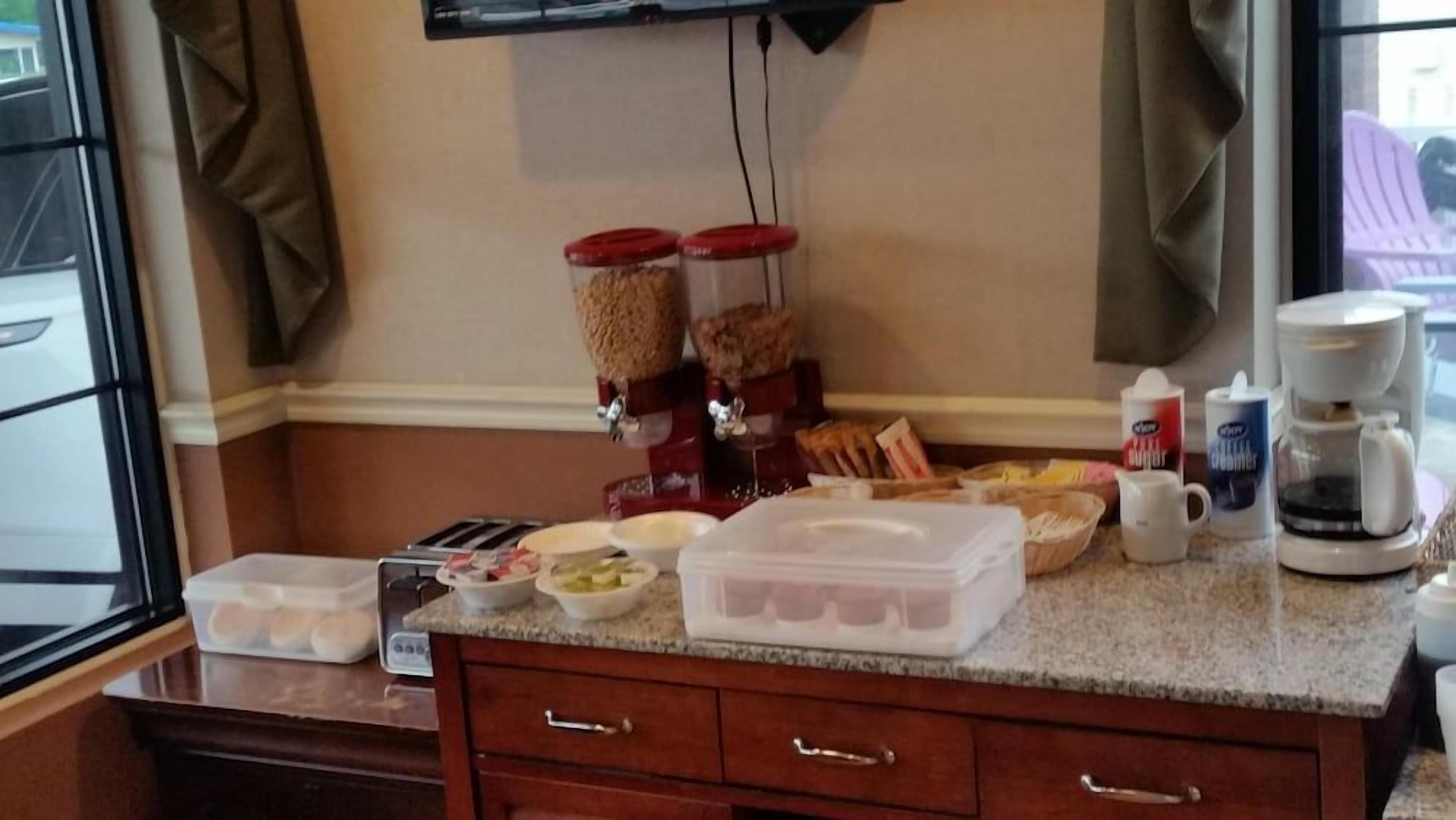 A kitchen counter with food items, a coffee maker, and a microwave.