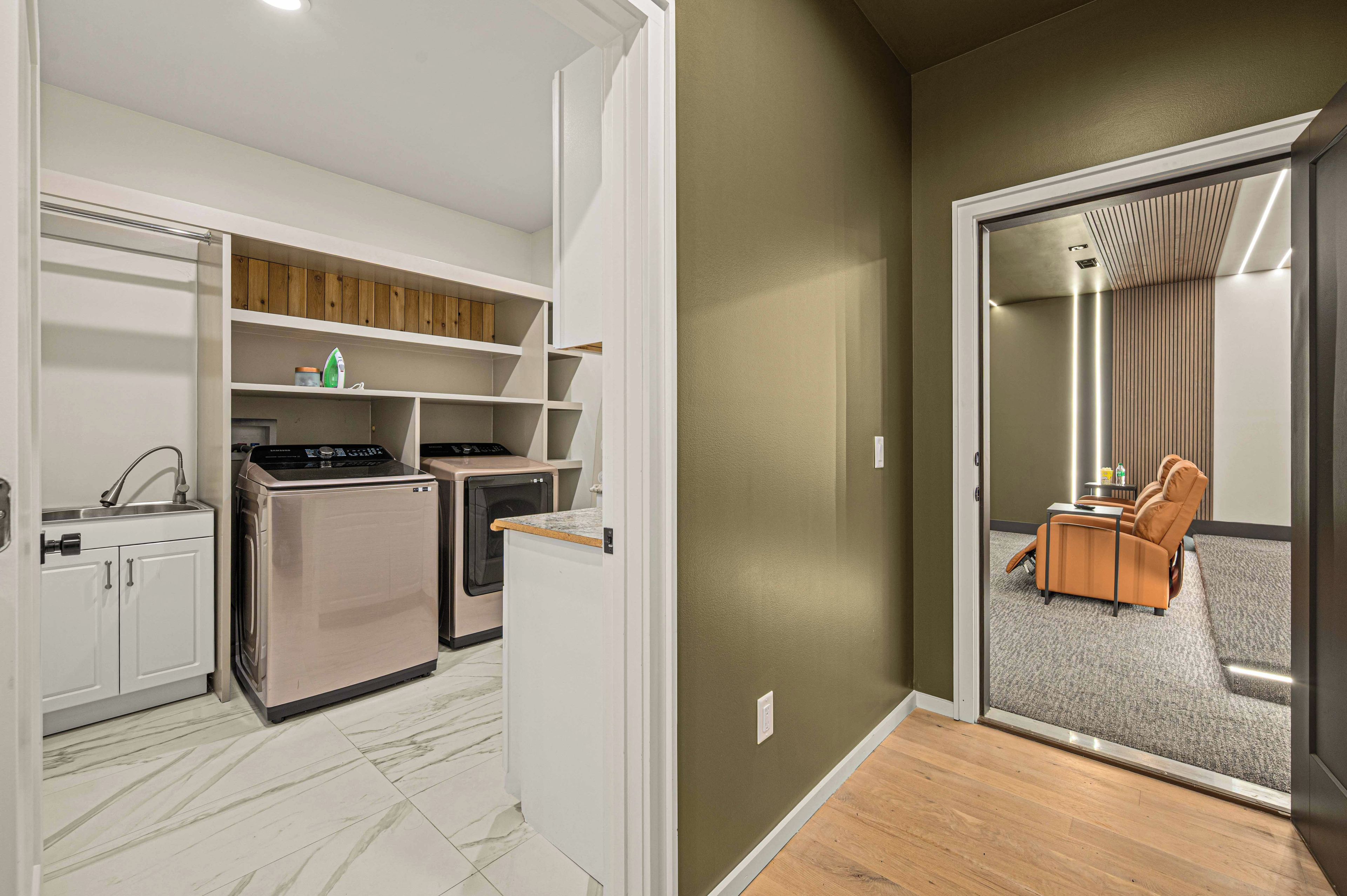 A compact kitchen with built-in appliances and a dining area with a sofa and table.