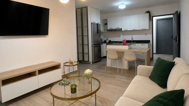 Una sala de estar moderna con un sofá, una mesa de centro y un televisor.