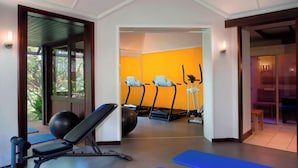 A gym with exercise equipment, including treadmills and a bench. - Le Meridien Ile des Pins (L'Île-des-Pins)