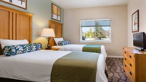 A hotel room with two beds, a dresser, a television, and a window with a view of trees. - Rare find- Spacious 2 bdrm condo during President's Day in Steamboat Springs (Steamboat Springs)