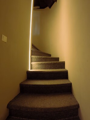 A carpeted staircase with a light fixture on the wall. - Camp & Hostel Maltakva (Poti)