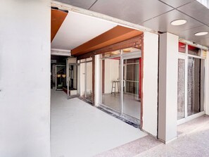 A hallway with a glass door entrance, a visible staircase, and a tiled floor. - Classic Hotel Gupta Palace (Ajmer)
