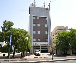 A modern hotel building with a sign for 'KRIOS A BOUTIQUE HOTEL' on the facade. - Classic Rivera Resort & spa (Silvassa)