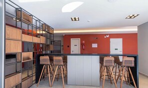 A modern interior with a bar area, seating, and a fire extinguisher.