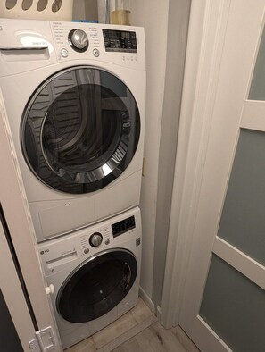 A stacked washer and dryer unit in a laundry room. -  NEW LISTING Water View Condo (St. Petersburg)