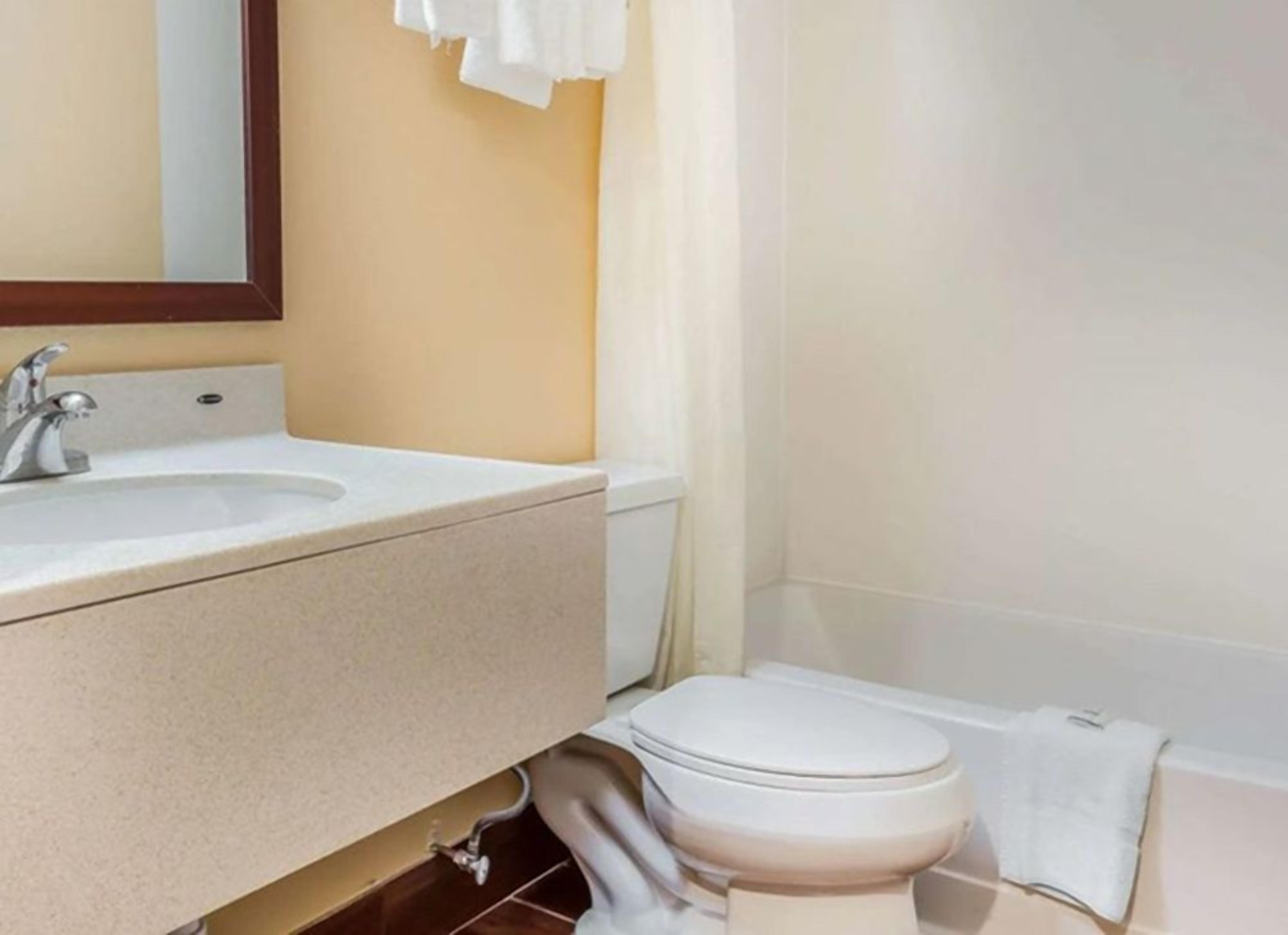 A bathroom with a sink, toilet, and bathtub.