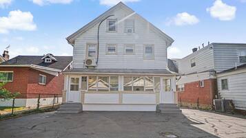 A two-story house with a covered porch and a garage.