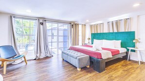 A hotel room with a bed, a chair, a table, and a view of the outdoors. - Miami Garden Retreat, Sleeps 8, Near Beaches (North Miami Beach)