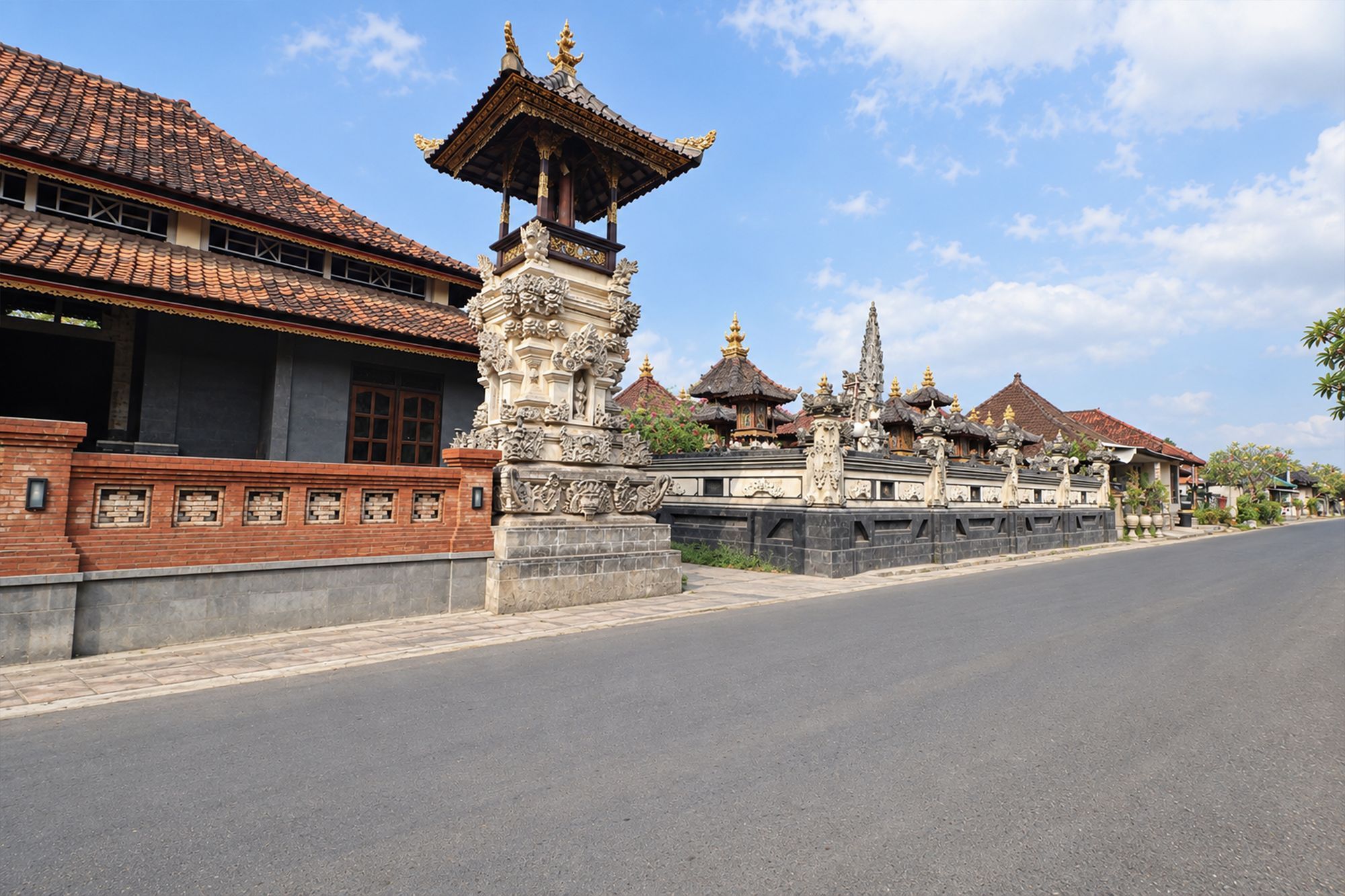 A street with traditional buildings, a clear sky, and a paved road.