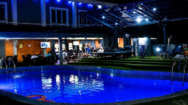 A swimming pool area with a covered seating area and a bar. - Seth Hotel Okwe Asaba (Asaba)