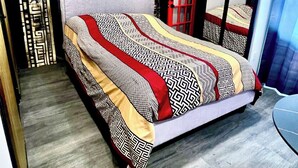 A modern bedroom with a bed, a desk, and a chair. - 1 Red Room private bathroom
In Luxury KIA   A1 (Richmond Hill)