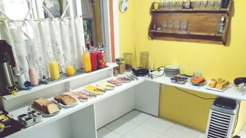 A breakfast buffet with various food items and beverages.