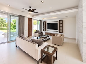 A modern living room with a sofa, armchairs, a coffee table, and a TV. - Jounieh House | Unique, Spacious Home with Private Pool (Cozumel)